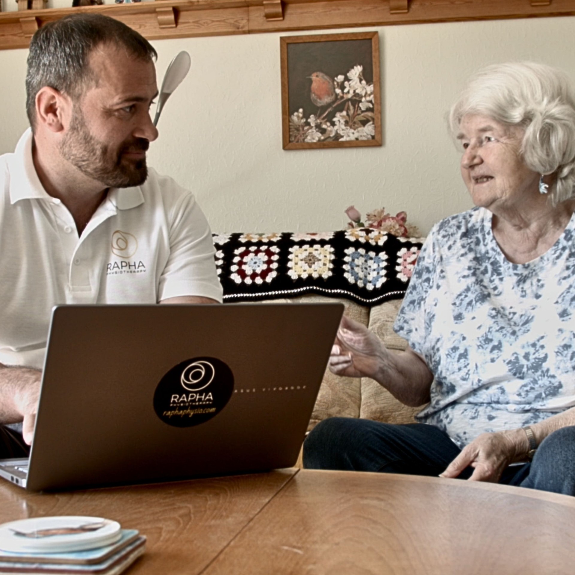 Physiotherapist consulting a patient at home
