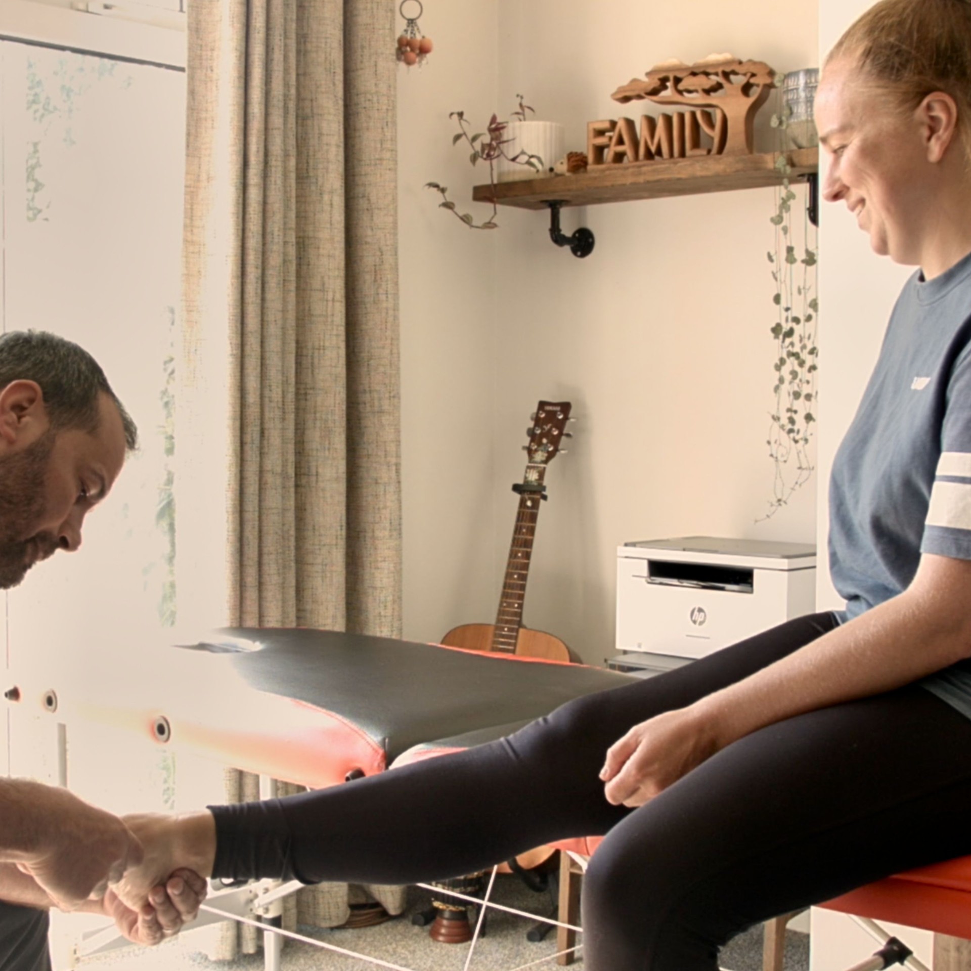 Physiotherapist examining a patient's foot